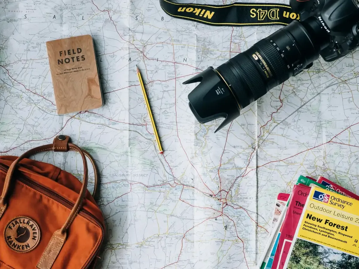 Carte, carnet et appareil photo préparés pour un voyage