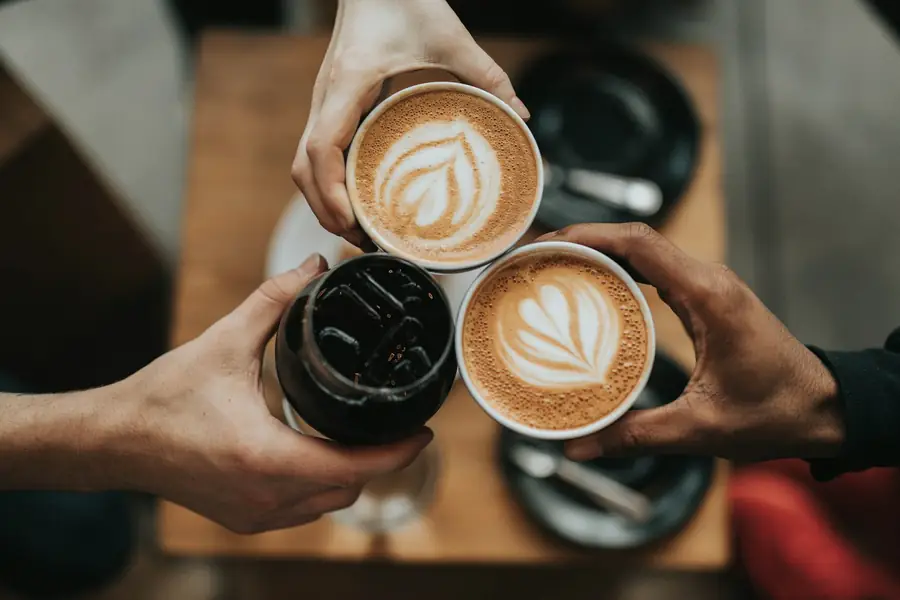 Deux cafés au lait sur une table en bois